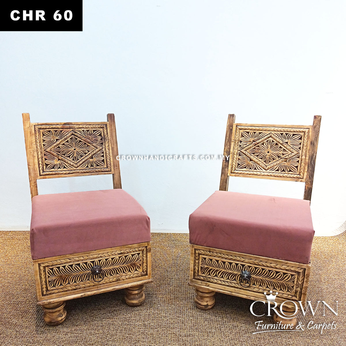 Low wooden accent chairs with decorative carved backs and pink upholstered cushions