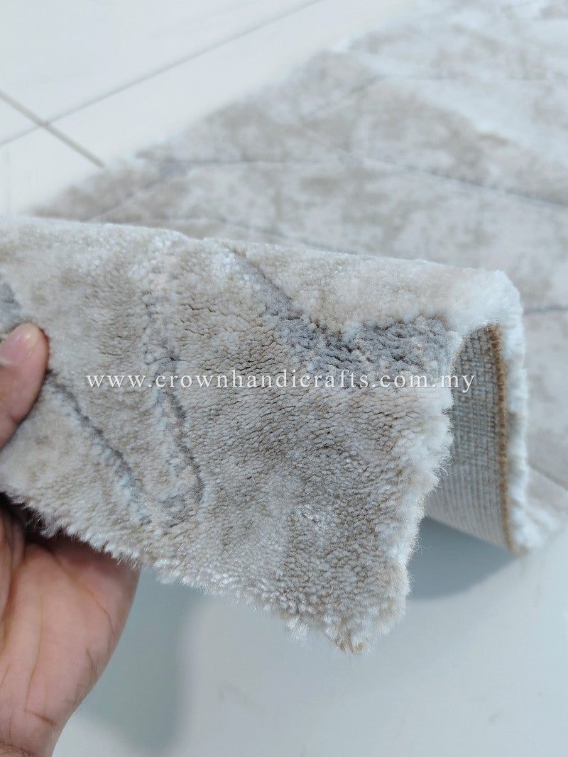 Close view of beige carpet runner edge showing dense, curly pile and stitched backing