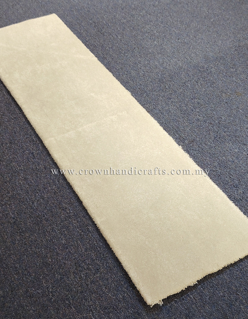 Cream runner rug laid flat, narrow rectangular shape with bound border.