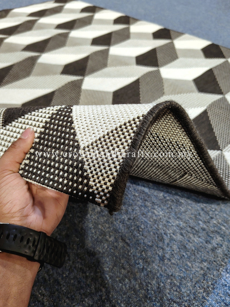 Geometric area rug with interlocking checkered cubes pattern in black, white and beige.