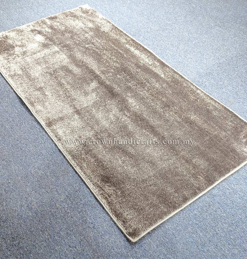 Beige runner rug with mottled texture and thin border on flat surface