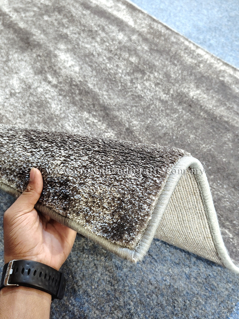 Dark gray runner rug edge with light backing, short textured pile visible
