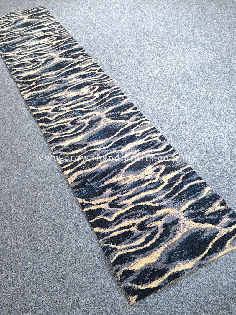 Modern runner rug with navy and beige wave-pattern texture, flat woven look.