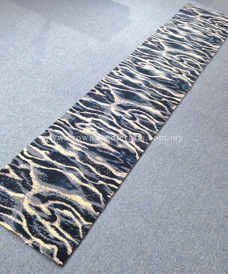 Wave-pattern runner rug with navy, cream, and beige tones; visible flat edge.