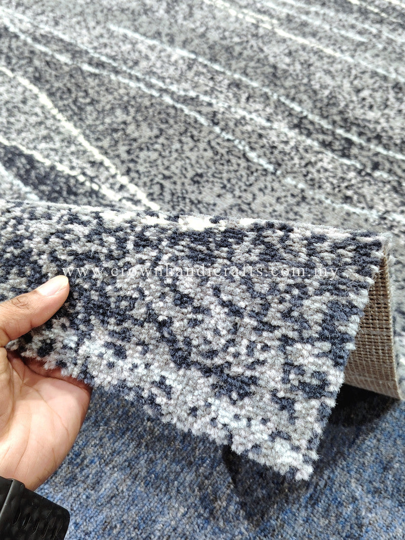 Close-up rug edge: cream and dark flecks with horizontal stripe-like texture
