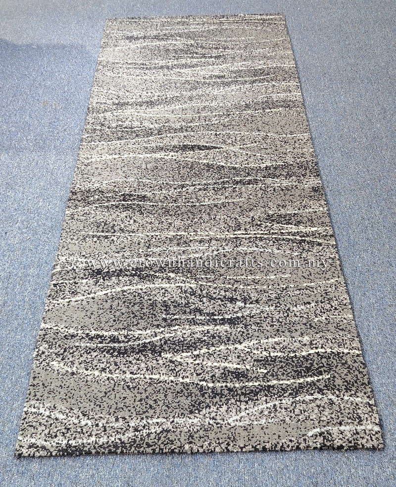 Abstract runner rug with beige and dark speckled horizontal stripe pattern, centered view