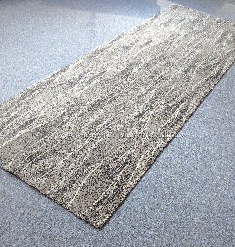 Abstract floor runner rug, beige with flowing line texture and dark speckled edge.
