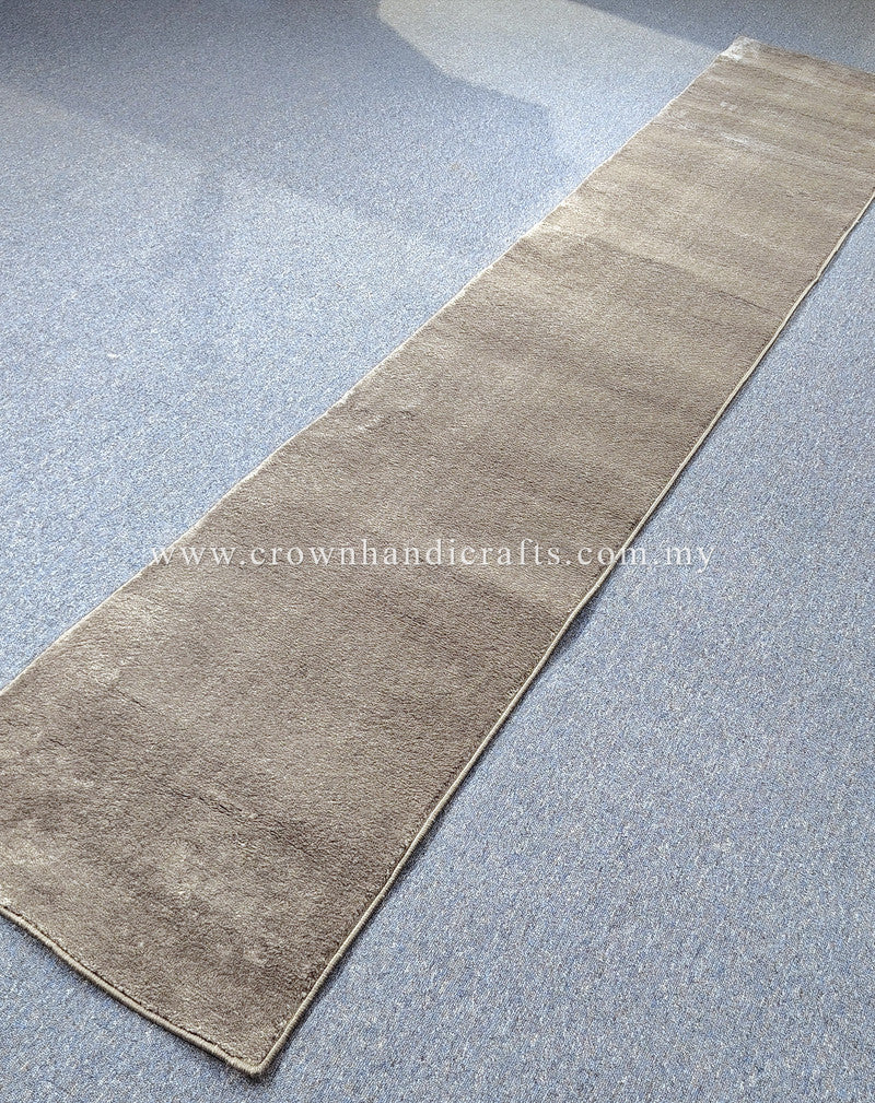 Hallway runner rug viewed diagonally, beige tone with muted mottled striping