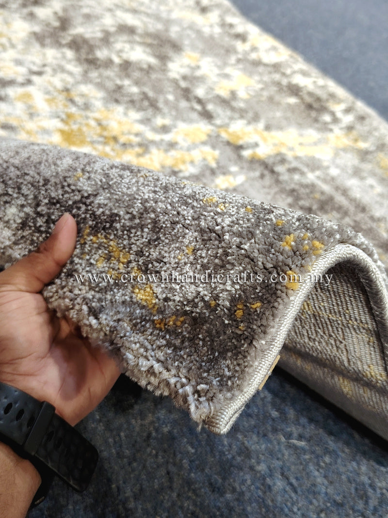 Hallway runner rug close-up: grey pile with yellow flecks and stitched border edge