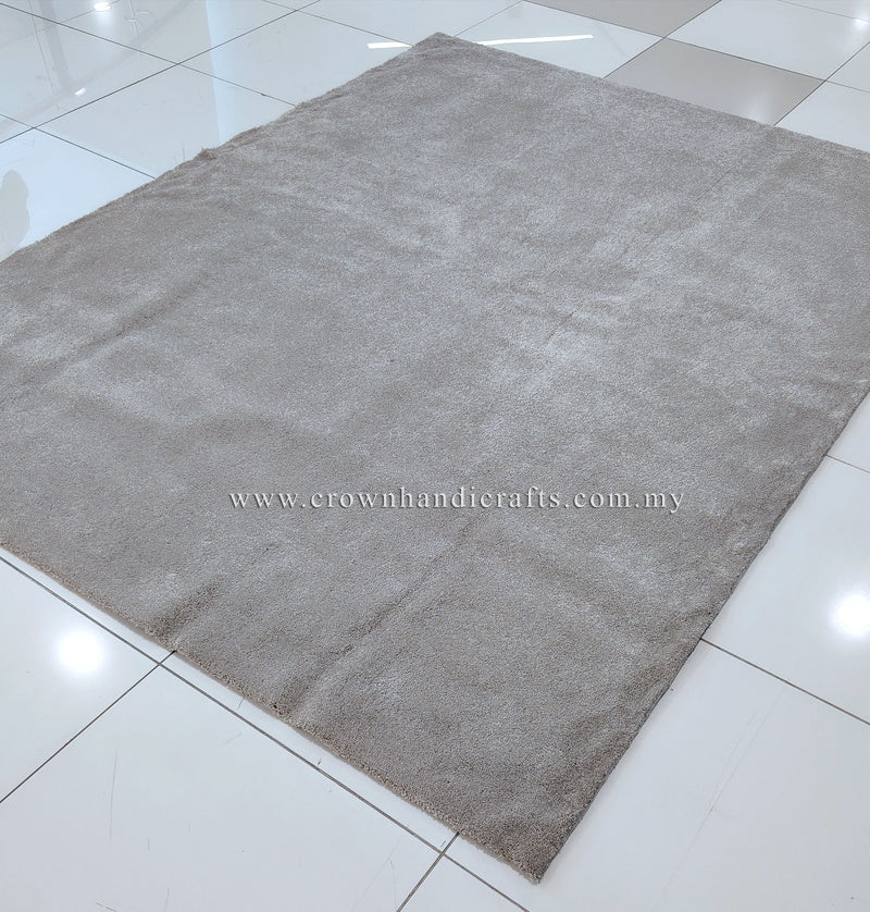 Plush rectangular area rug with soft short pile in light gray-beige, flat lay
