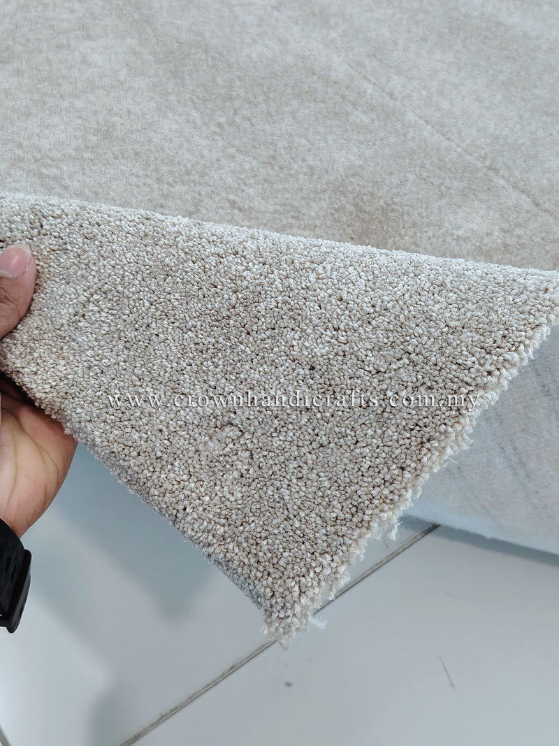 Plush area rug with short, dense pile in light beige, folded at the corner
