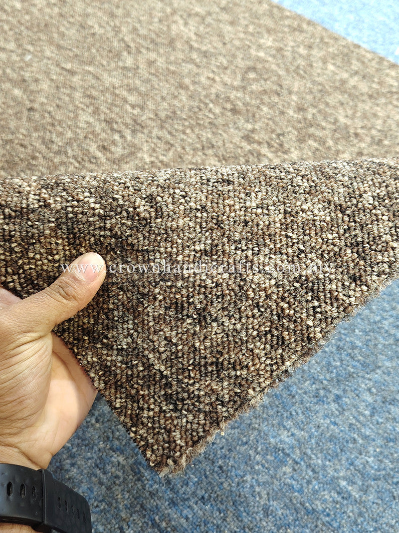 Brown textured rug corner detail with visible low pile texture and backing