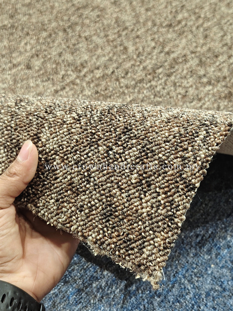 Rectangular textured rug held at corner, tight loop pile with short frayed edge