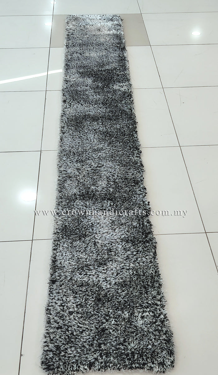 Long narrow shaggy runner rug in black-and-white, centered on tiled floor