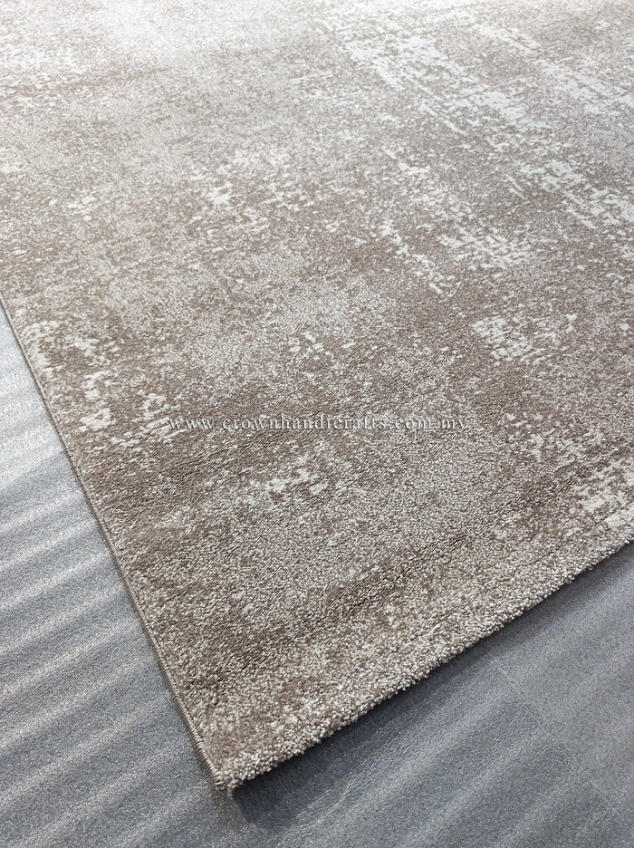 Abstract area rug with distressed beige and white surface, corner and border shown.