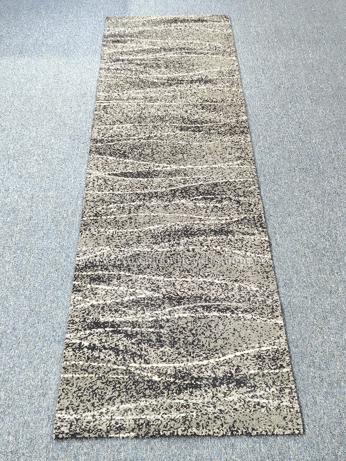 Beige and dark speckled abstract runner carpet with horizontal stripe bands, flat view.