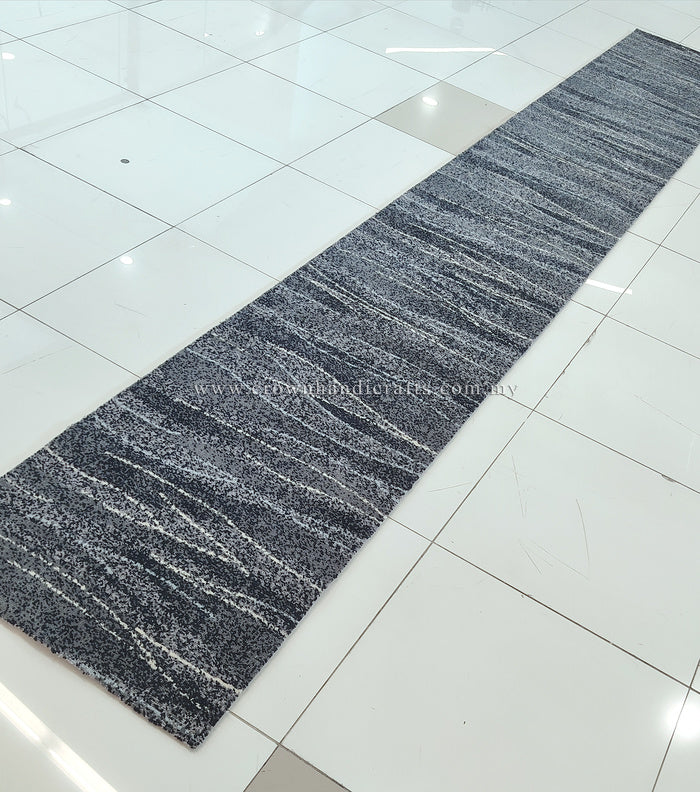 Abstract runner rug with dark blue-gray stripes and speckled texture, long hall size
