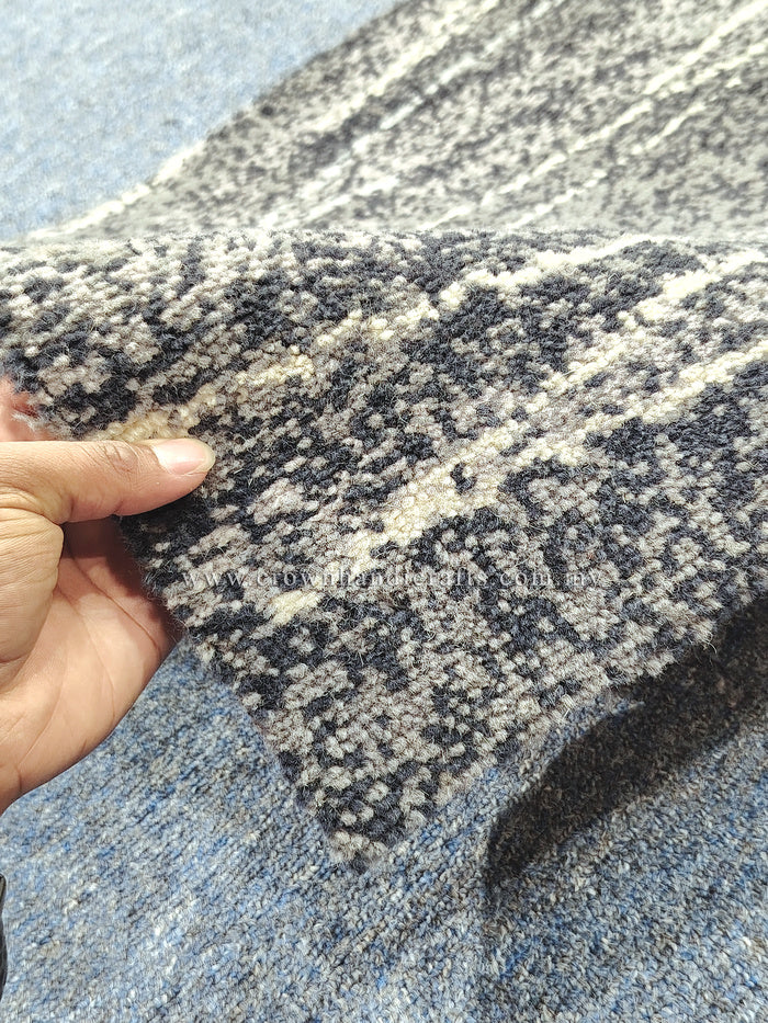 Close-up abstract runner rug texture in navy and light speckled fibers