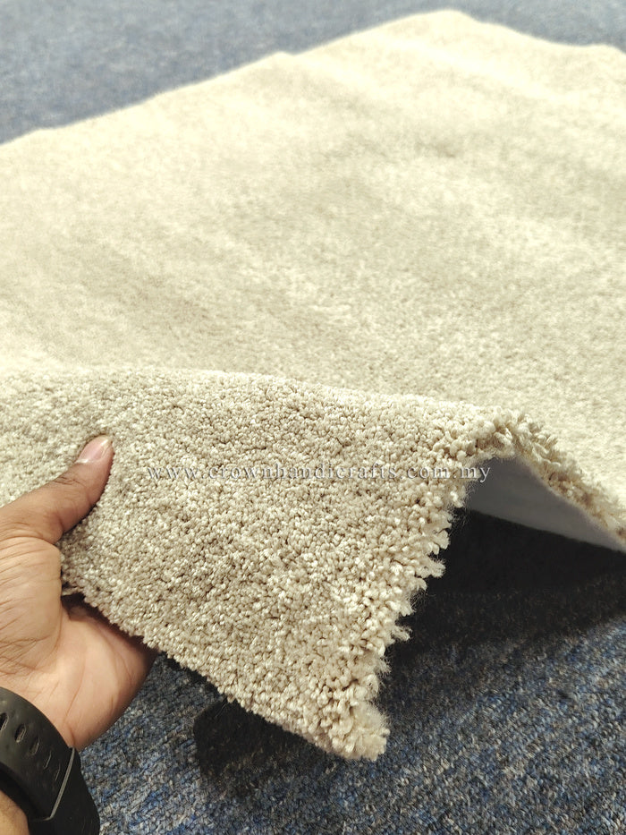 Plush beige comfort mat with shaggy pile; hand holds curled corner for thickness