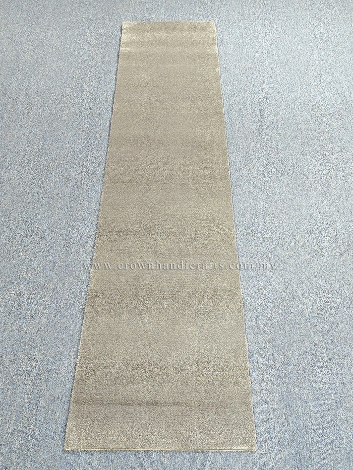 Beige runner rug laid flat with simple solid design and low, even texture
