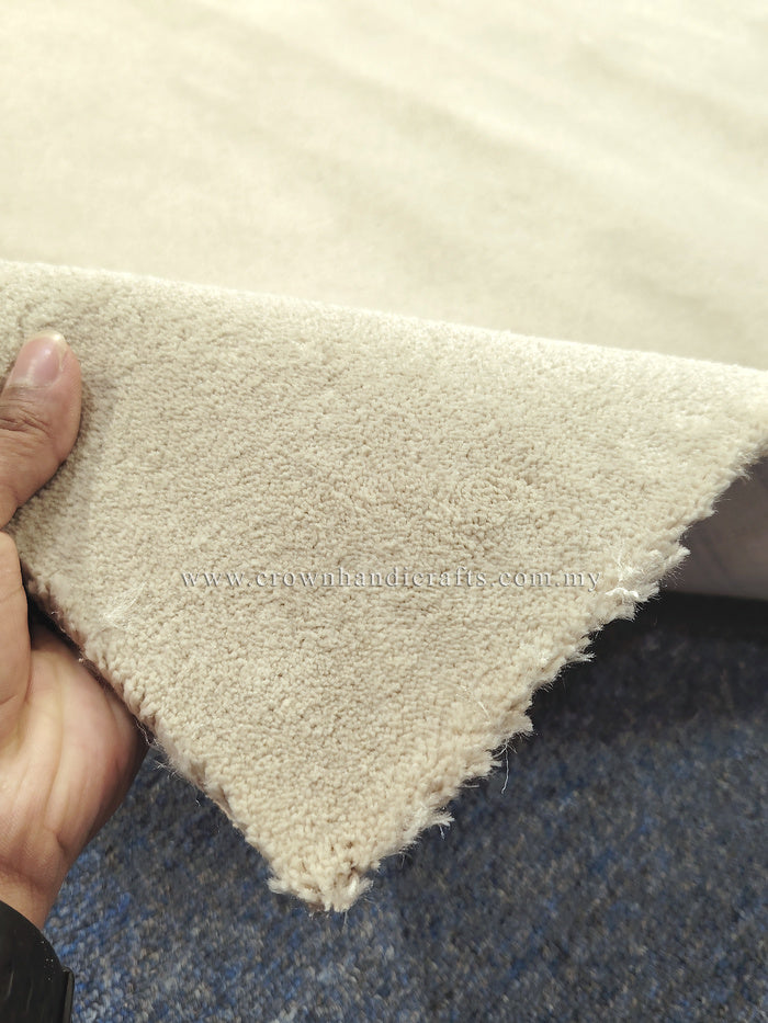 Oatmeal-beige runner rug corner with dense soft pile and stitched-looking edge
