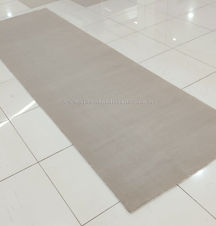 Oatmeal beige runner rug, angled view showing flat low pile and minimal pattern.