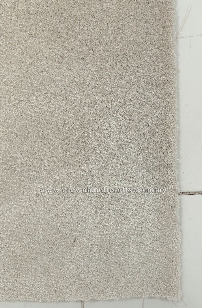 Oatmeal beige runner rug with short fringe along one edge, close-up texture view.
