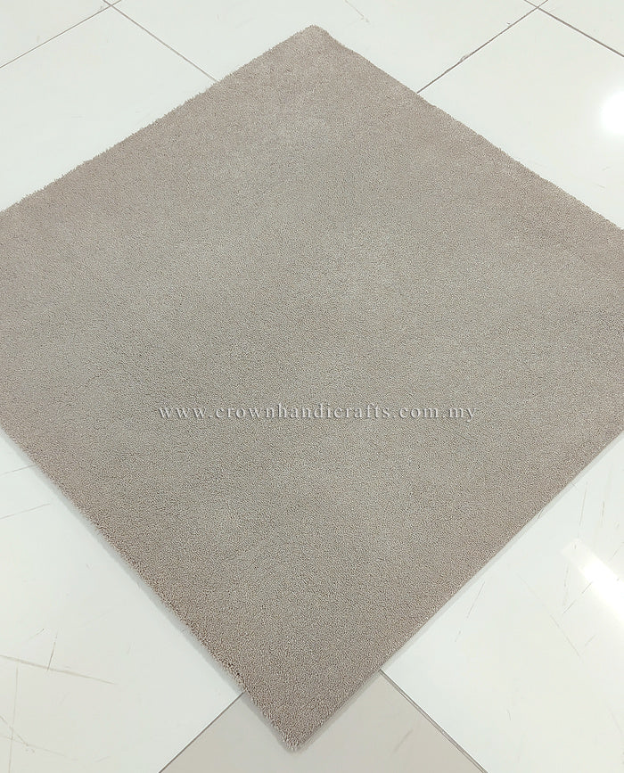 Light brown square area rug with short, dense low-pile texture