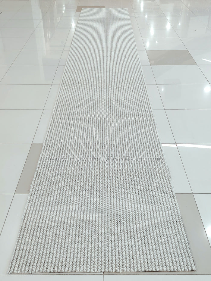 Natural runner rug on floor, long narrow rectangle with looped texture
