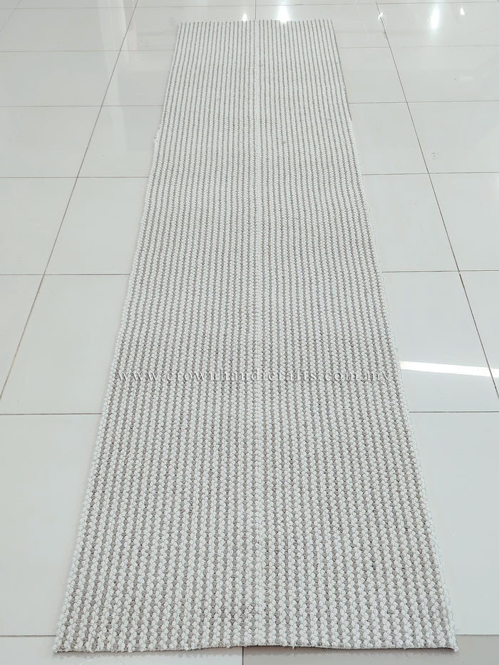 Natural-tone woven runner carpet with dense grid weave, laid flat on floor