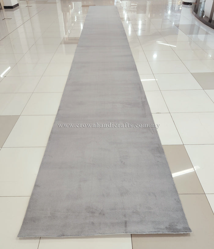 Grey long runner rug with muted mottled look and soft low pile.