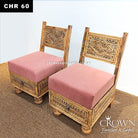 Pair of low wooden chairs with ornate carved panels and pink cushioned seats