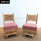 Low wooden accent chairs with decorative carved backs and pink upholstered cushions