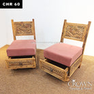 Two carved wooden low chairs with open storage space under pink seat cushions