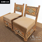 Low wooden chair with beige padded cushion and carved geometric Rajasthani front panel