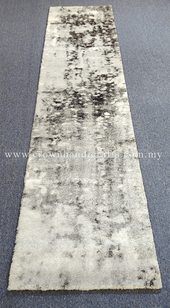 Beige runner rug with dark abstract patches, short plush texture