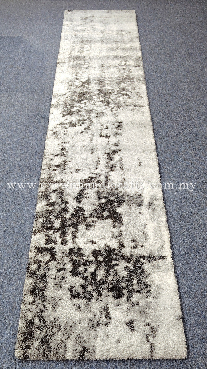 Beige runner rug with large dark mottled abstract motif, short plush pile