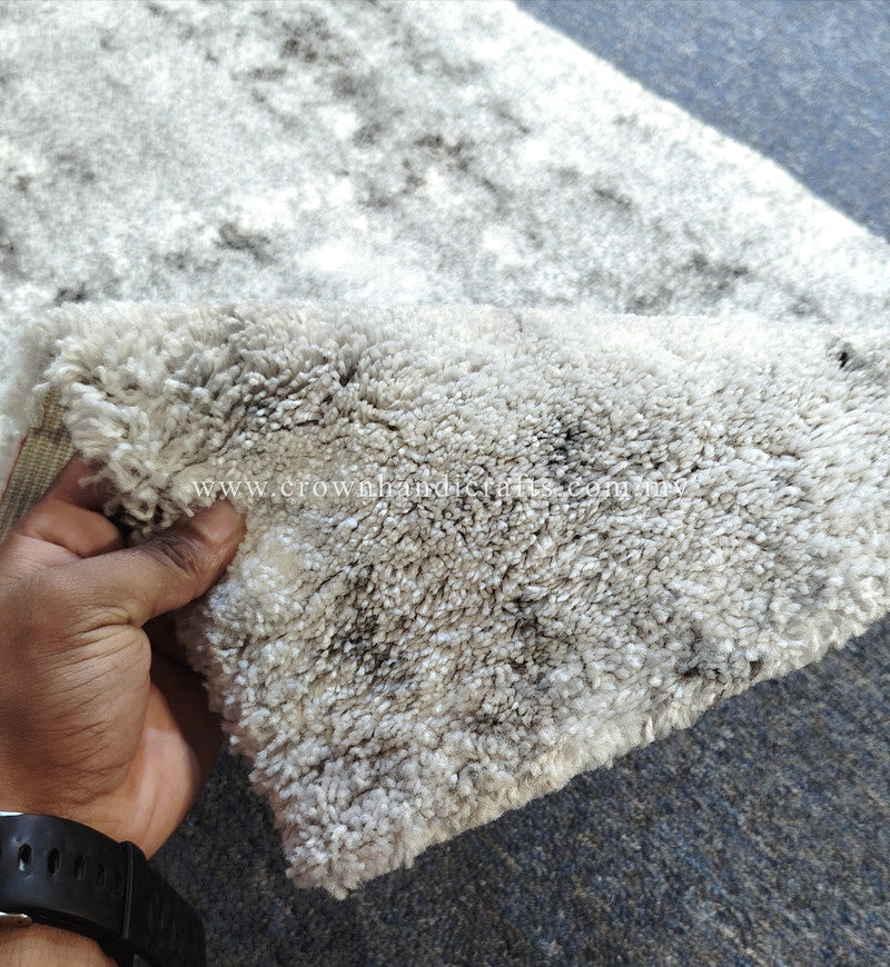 Light beige runner rug corner detail, short plush pile with mottled abstract design