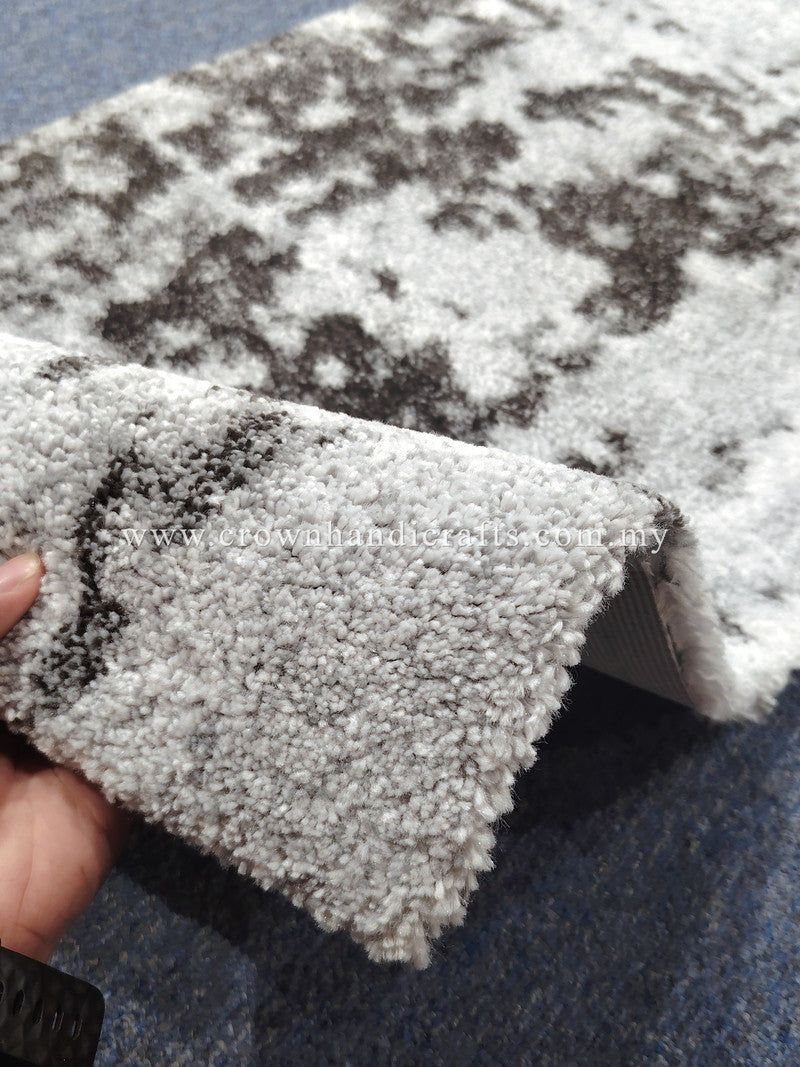 Runner rug edge with thick short pile and dark speckled abstract pattern