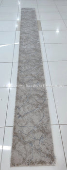 Narrow extra-long beige runner rug with abstract motif and textured surface