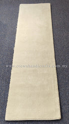 Cream runner rug, slim narrow rectangle with soft plush surface and bound hem.