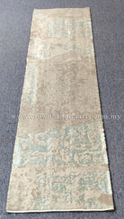 Beige runner rug with light teal distressed pattern, even flat weave surface