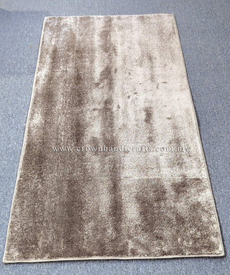 Beige runner rug with shimmering mottled finish and detailed perimeter border