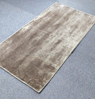 Beige runner rug with subtle distressed pattern, flat woven look and border