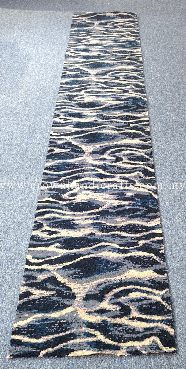 Narrow modern runner rug featuring high-contrast wave pattern in navy and beige tones.