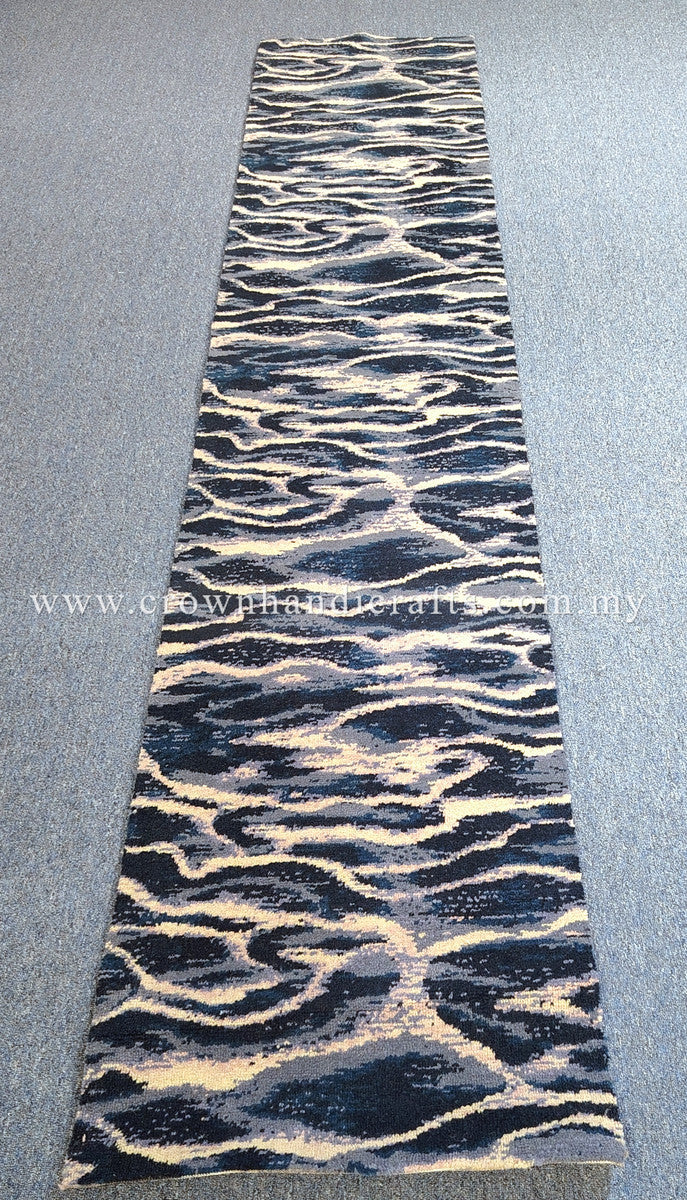Straight-on view of modern wave-pattern runner rug in dark navy with beige highlights.