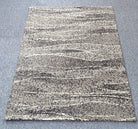 Abstract area rug, cream base with dark charcoal marbled horizontal stripe pattern