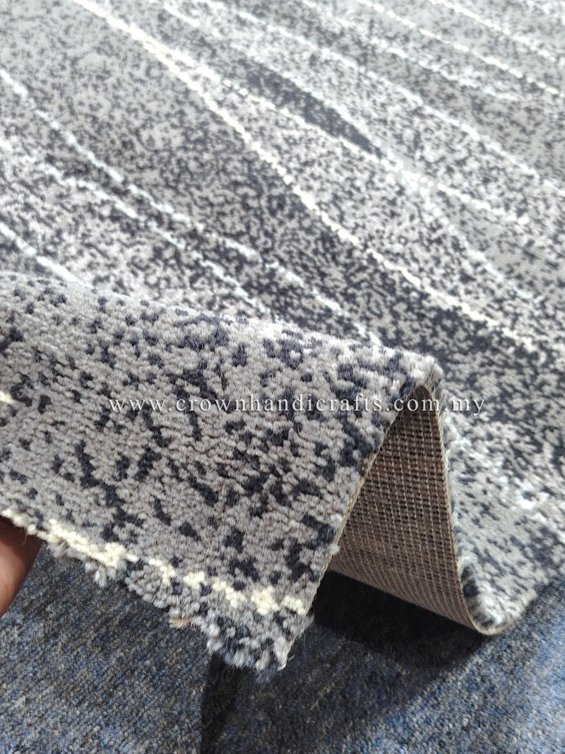 Area rug edge detail, cream base with dark charcoal speckled stripe pattern
