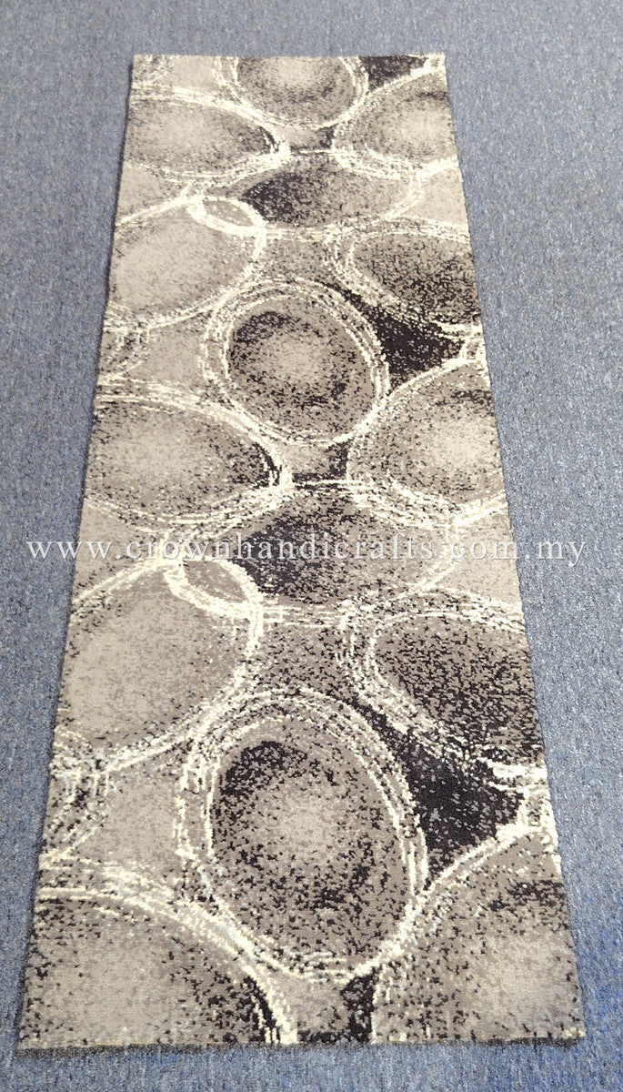 Slim runner rug featuring swirling abstract circles in beige, gray, and dark speckles