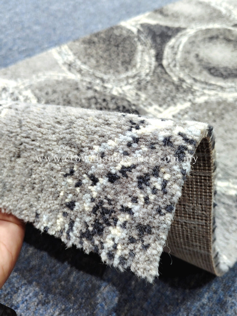 Abstract runner rug with speckled dark circles on light gray, textured cut-pile edge